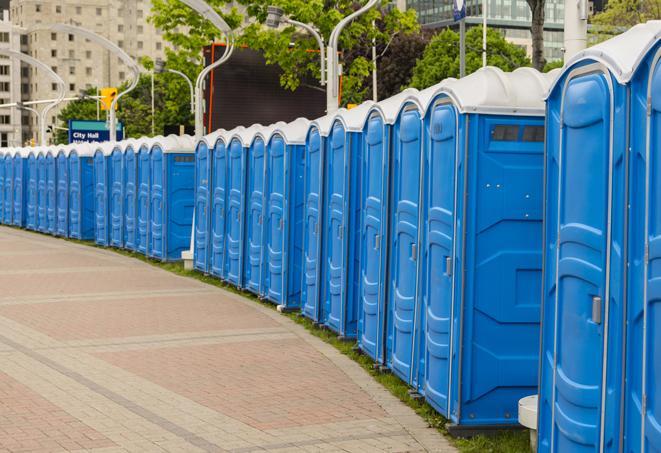 a row of portable restrooms set up for a large athletic event, allowing participants and spectators to easily take care of their needs in Hanover MA